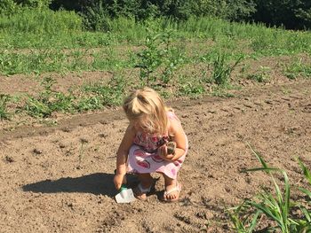 Girl digging on field
