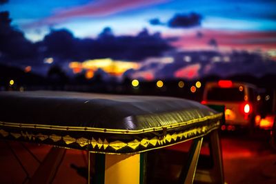 Close-up of illuminated lights against sky at night