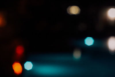 Defocused image of illuminated street lights at night
