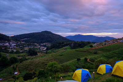 Scenic view of field and mountains against sky