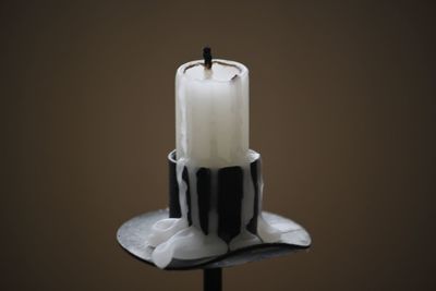 Close-up of candles on table against black background