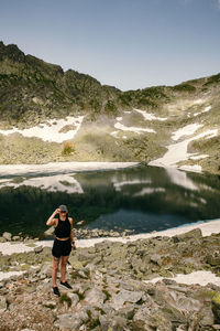 Full length of man on rock against sky