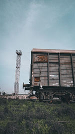 Abandoned truck on field against sky