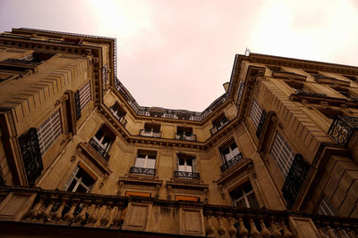 Low angle view of buildings in town against sky