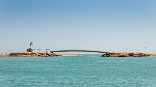 Scenic view of sea against clear blue sky