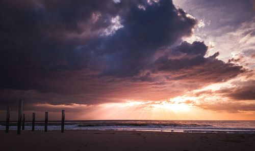 Scenic view of beach against sky during sunset