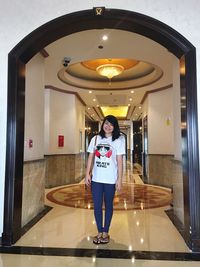 Rear view of woman standing in corridor