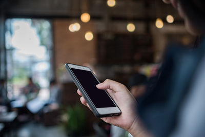 Midsection of man using mobile phone