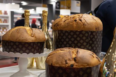 Panettone, italian sweet cakes typical of christmas time and fine champagne bottles.