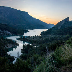 Scenic view of lake and mountains against sky