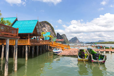 Scenic view of river by mountains against sky