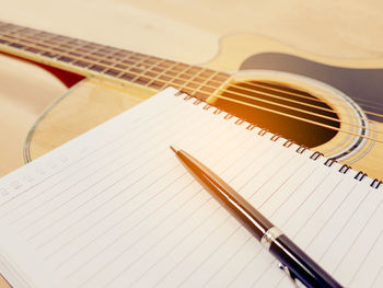 Close-up of guitar on table