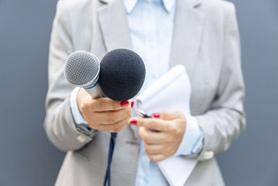 Female reporter holding microphone during media interview. freedom of the press concept.