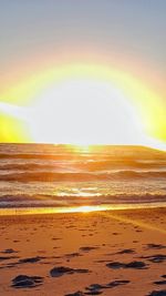 Scenic view of beach against sky during sunset