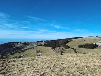 Scenic view of landscape against blue sky