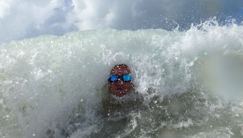 Man splashing water in sea