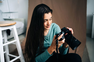 Young woman photographing through camera