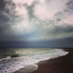 Scenic view of sea against cloudy sky