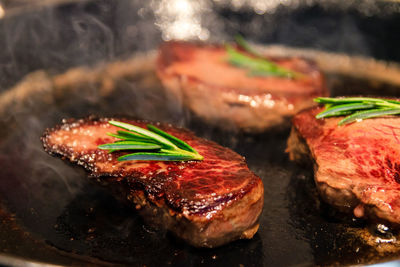 Close-up of meat on barbecue grill