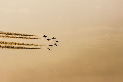 Low angle view of airplane flying against sky