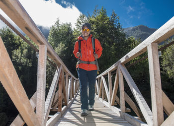 Woman crossing wooden bridge at caleta gonzalo in chile