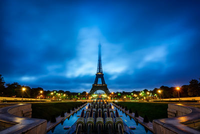 View of illuminated building against cloudy sky