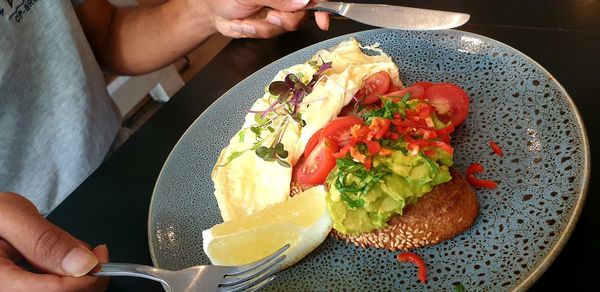 High angle view of person having breakfast in plate