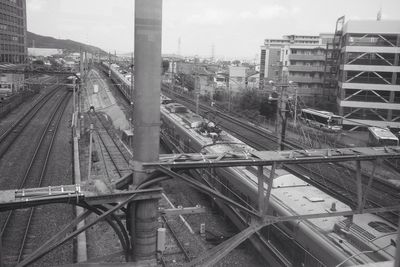 High angle view of railroad tracks in city against sky