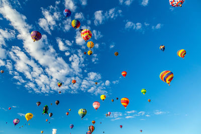Low angle view of multi colored balloons in sky