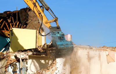 Abandoned construction site against clear blue sky