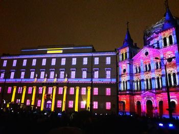 Low angle view of illuminated building against sky at night