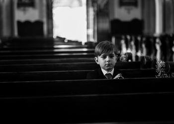 Child praying in a catholic church