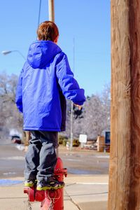 Rear view of girl standing outdoors