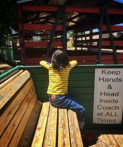 Full length of woman standing on bench