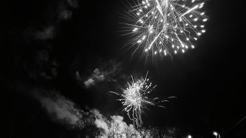 Low angle view of firework display at night