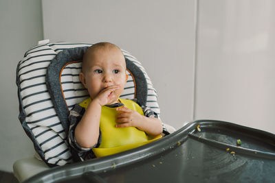 Little child with solid nutrition. baby girl eating food and mix vegetable plate