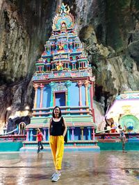 Full length rear view of woman standing outside temple