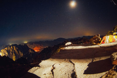 Scenic view of illuminated mountains against sky at night