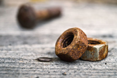 Close-up of rusty bolts on table