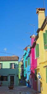 Multi colored buildings against blue sky