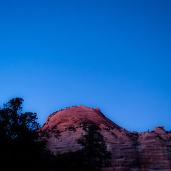 Low angle view of rock formations against blue sky