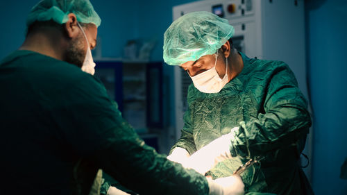 Team of surgeons doing an operation. sterile operating room.