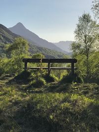 Scenic view of field and mountains against clear sky