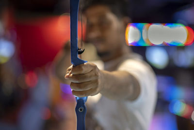 Close-up of hand holding illuminated lighting equipment