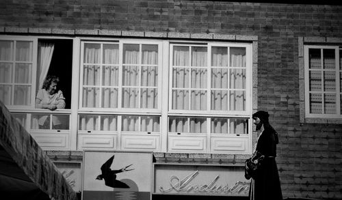 Woman standing in front of building