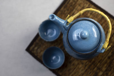 Blue ceramic teapot set on gray background drinking tea each day each person often has a different 