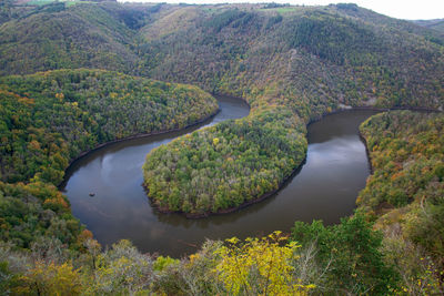 Scenic view of river by mountains