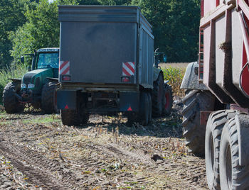 Tractor on field against trees