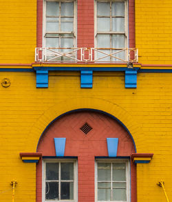 Low angle view of yellow windows on building