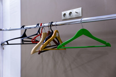 Colorful coathangers hanging on rack at home